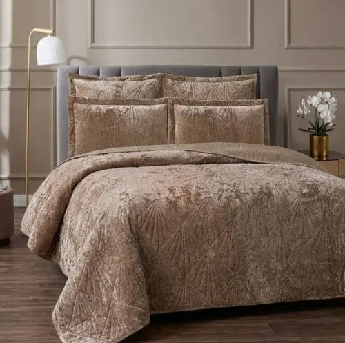Layered linen bedding on a softly-lit bed